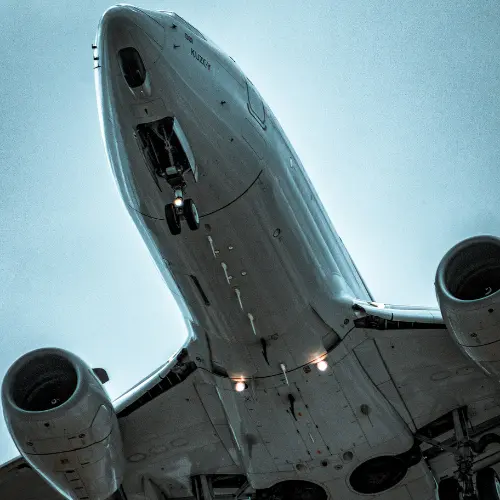 Commercial aircraft on approach, underside view